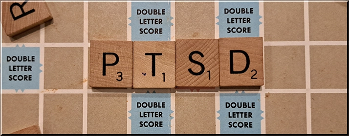 PTSD spelled out on a Scrabble board.